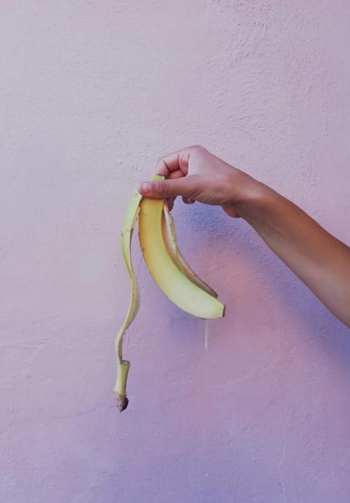 Arm holding banana peel